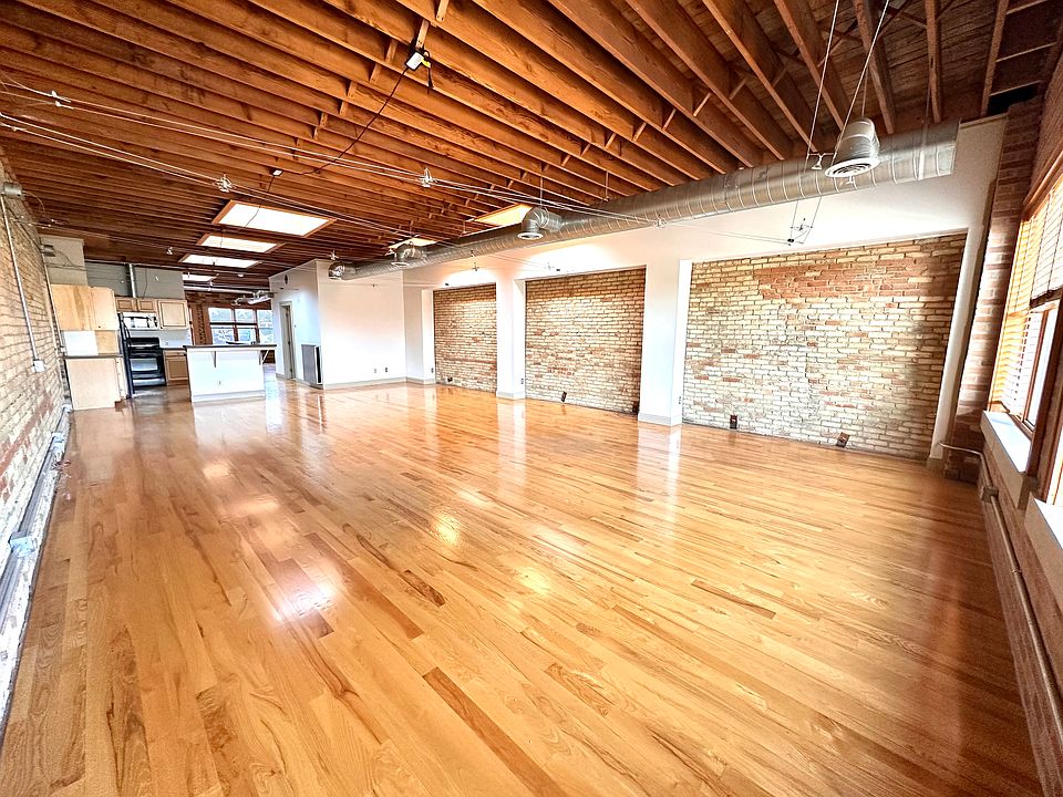Huge open space with gorgeous natural light, tall ceilings, and exposed brick walls