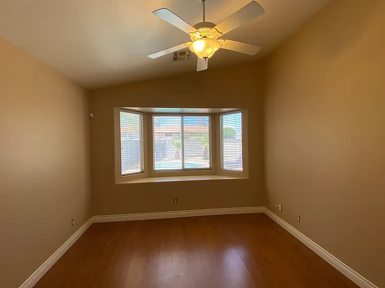 Master bedroom with bay window view of pool.