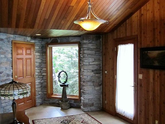 Absolutely stunning entry room. The detailed cedar slats give a rustic elegance to this beautiful home