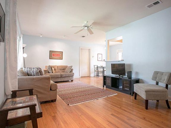 Hardwood floor throughout living room.