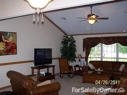 Living room with vaulted ceiling.