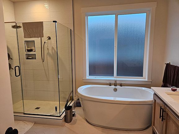 Master Bath with glass enclosed shower and tub.