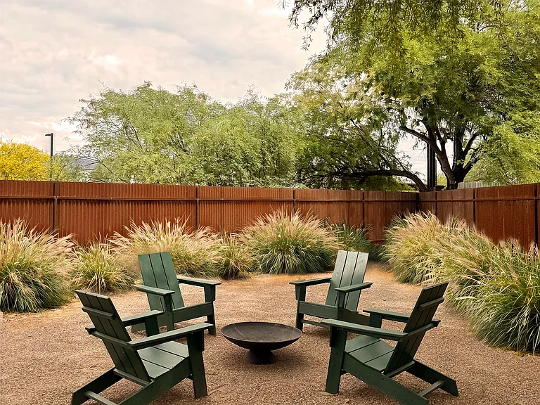 Fenced backyard fire pit lounge - a quiet, private space to unwind after a long day.