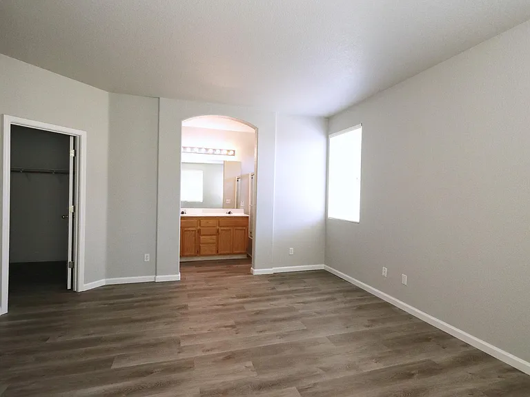 Master Bedroom with separate full bathroom, ceiling fan, window blinds, large walk-in closet