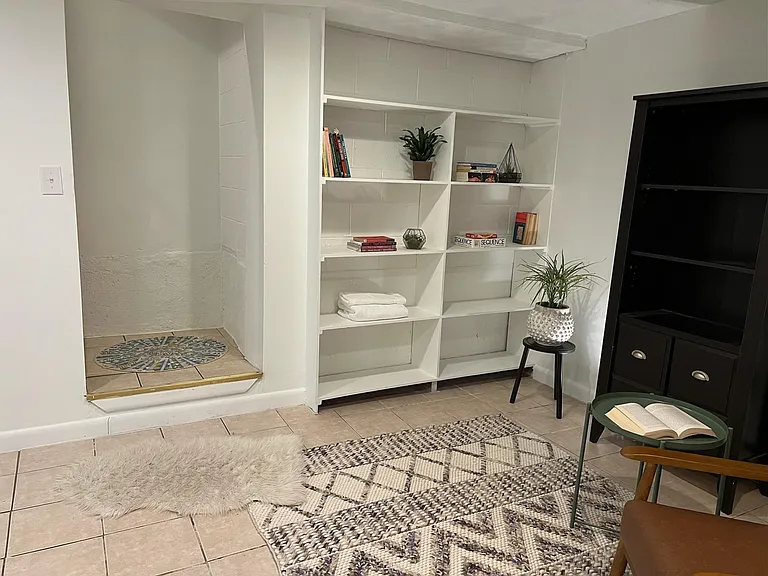 Downstairs bonus room; please note that we have installed new wood flooring throughout this space as well as a door for privacy.