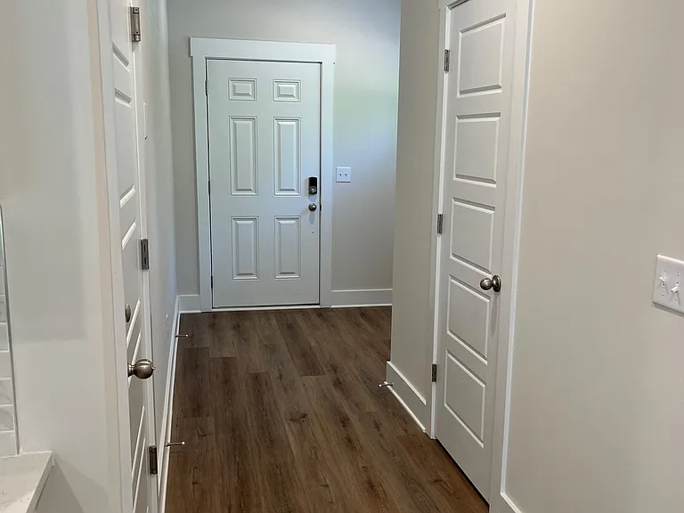 main downstairs hallway, looking and front door. garage door on left, half bath door on right