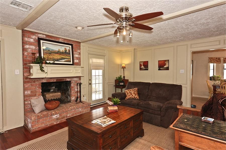 Warm and relaxing Family Area with brick fireplace Gorgeous wood mantle with paned glass door leadin