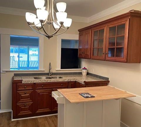 Large eat-in kitchen with small island on wheels and mud room beyond
