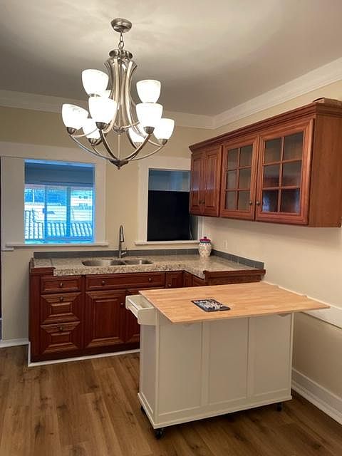 Large eat-in kitchen with small island on wheels and mud room beyond