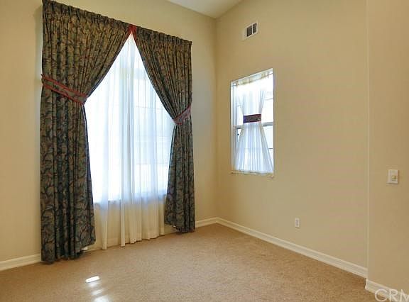The downstairs bedroom/office showing drapes and new carpet.