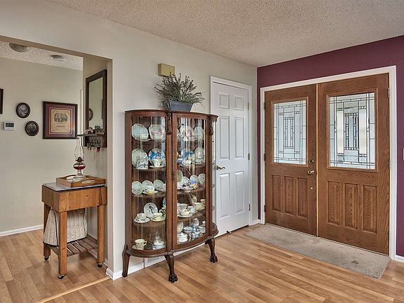 Leaded-glass double front doors welcome you into a entertainer's home with wood 