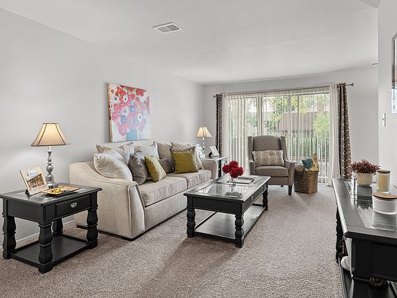 Open and airy living room with natural lighting at Knottingham Apartments in Clinton Township, MI.