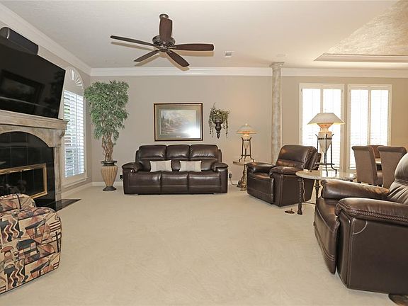 Immediately to your left as you enter the home is aformal Living room, that the current owners haveused as their media room. Plantation shutters arethroughout the home, as well as crown moulding.