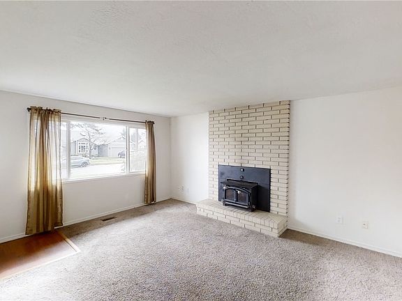 Living Room features a wood burning fireplace and lots of natural light.