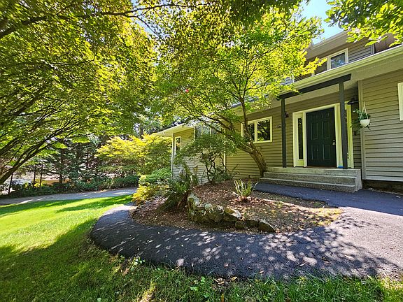 Front door with paved access to lower portion of the home and garages.