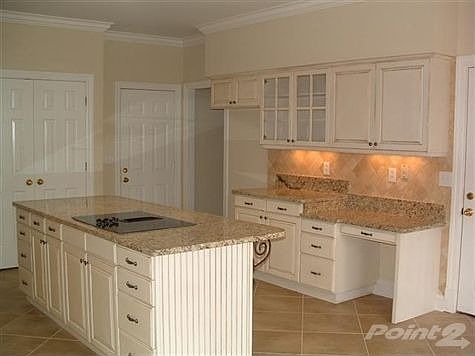 ANOTHER VIEW OF KITCHEN WITH BUILT IN WORK DESK AND LARGE PANTRY.