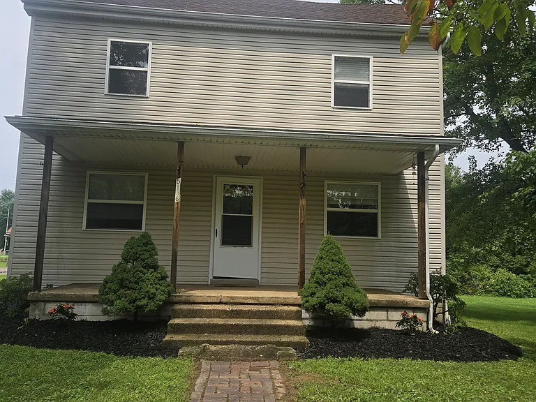 Landscaped front entrance with covered porch