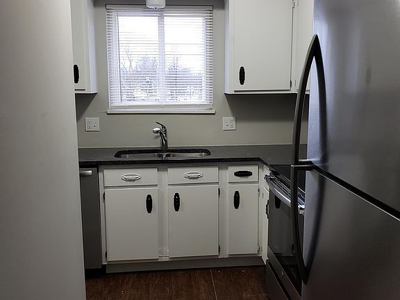 Kitchen with new granite counter-top, new stainless steel appliances, and freshly painted cabinets