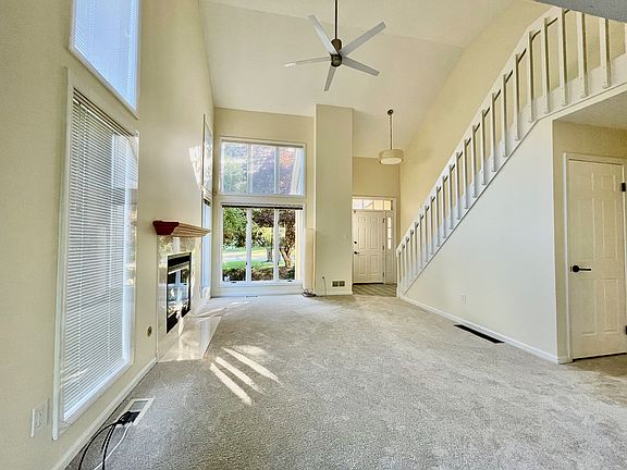 Living room with cathedral ceilings and gas fireplace.