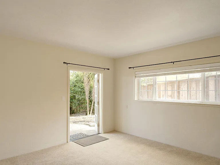 Bedroom #3 - Currently Unfurnished. Patio Access. (Fireplace is decorative only)
