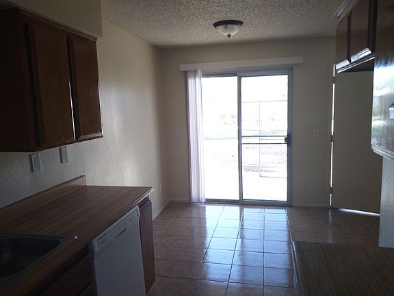 View from kitchen of dining area and slider door to private fenced patio