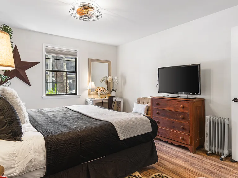 Comfortable King bed in the bedroom. Includes a smart TV, desk to get ready at, dresser and a closet to store your items in.