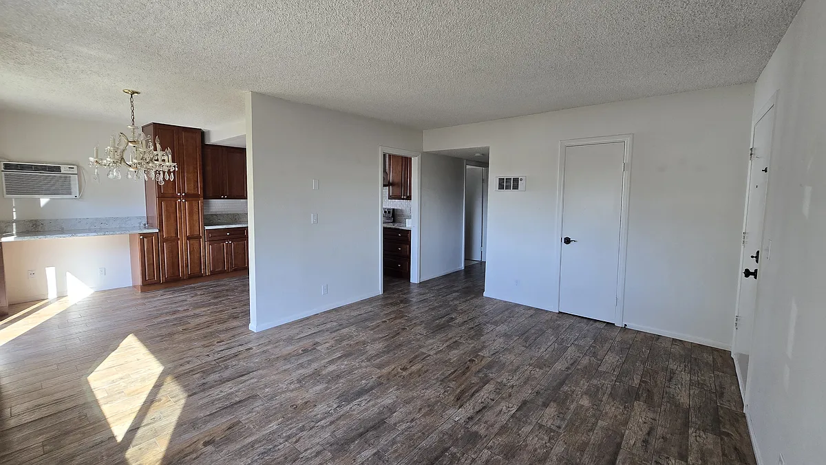 Living Room This inviting living room offers a generous layout with plenty of natural light streaming in through large windows. The open design creates a warm and airy feel, perfect for relaxing or entertaining. - 1865 E Grand Ave #C