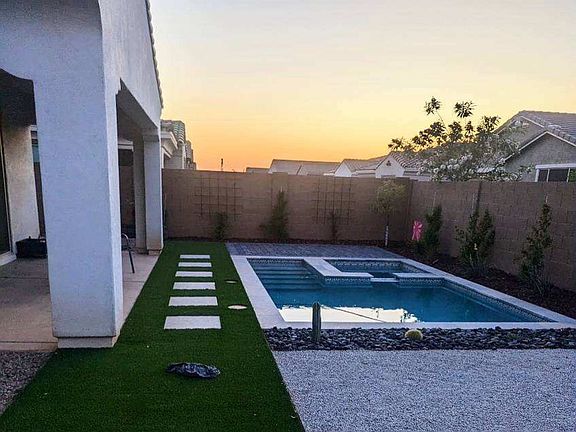 fully landscaped backyard with large covered porch