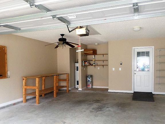 Garage with shelving, workbench and space to hang-up tools.