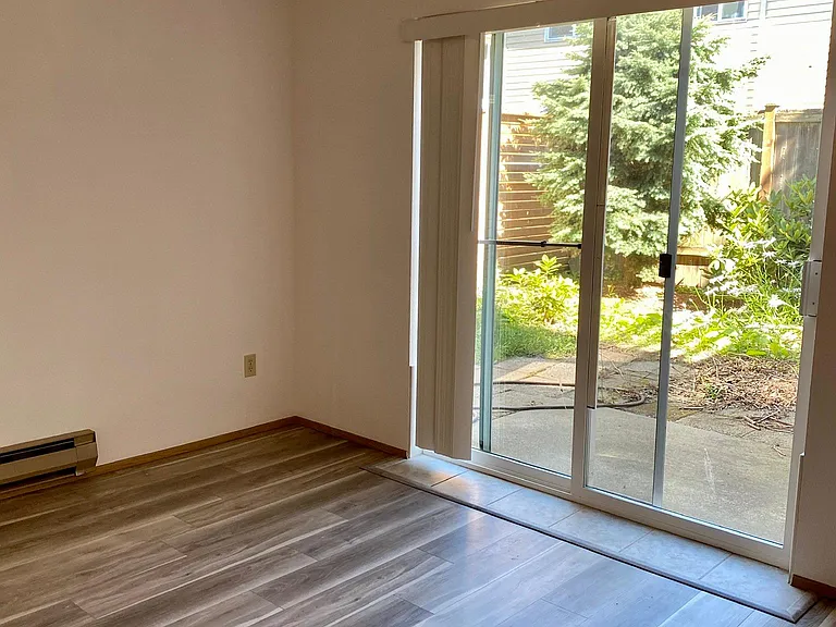 One of the bedrooms with sliding door to the fanced backyard.