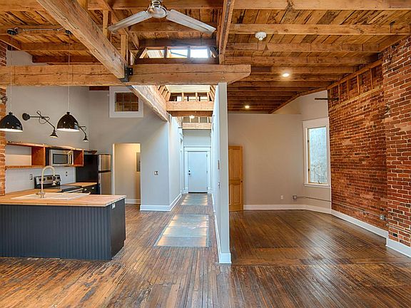 This is looking at one room (right side of photo) that has three walls and opens to the living area.