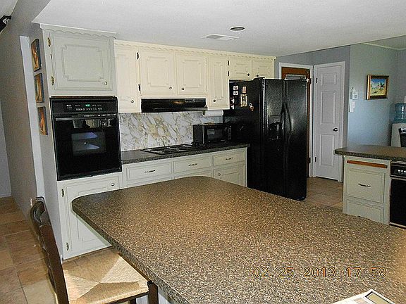 Another view of the kitchen, oven, cook top