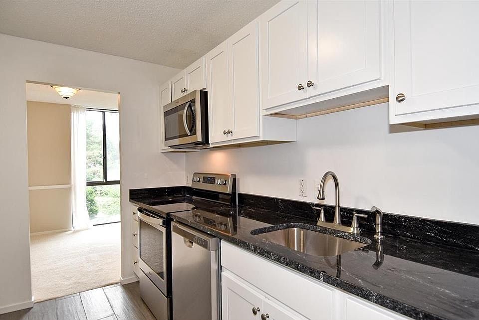 Kitchen with new stainless steel stove, microwave and dishwasher