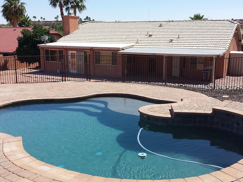 Fully gated pool and rear view of home