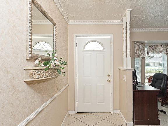Inside, you are greeted with a tiled Entry with chair rail, designer paint and spindles atop a pony 