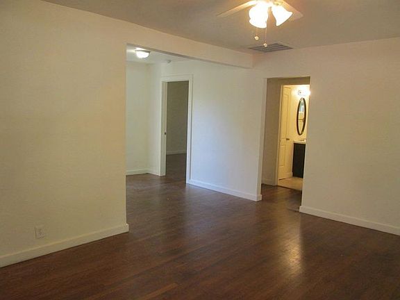 LIVING ROOM LOOKING TOWARDS BACK BEDROOM AND HALLWAY TO BATHROOM AND FRONT BEDROOM