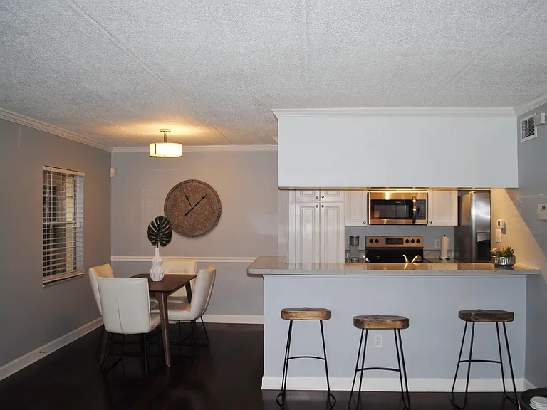 Staged dining room and kitchen view
