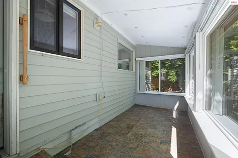 sunroom outside kitchen window leading to the backyard