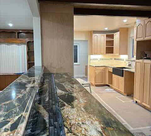 View from dining area and counter into kitchen