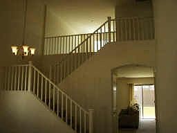 Custom railings lead from living/dining room to spacious loft