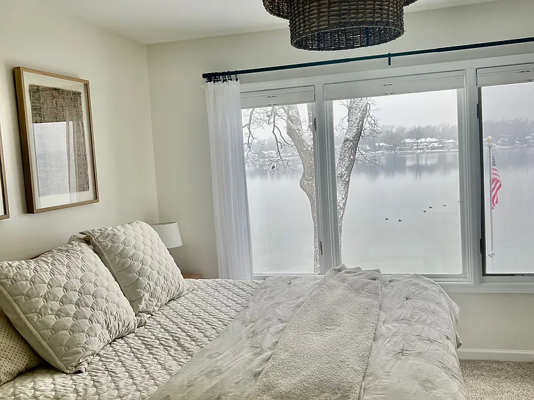 Bedroom 1 with king bed, closet and lake views