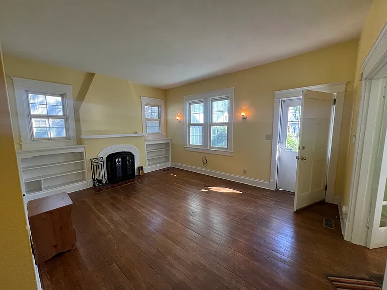 The roomy den front of house ,original french glass doors into dining room, intom kitchen nice flow