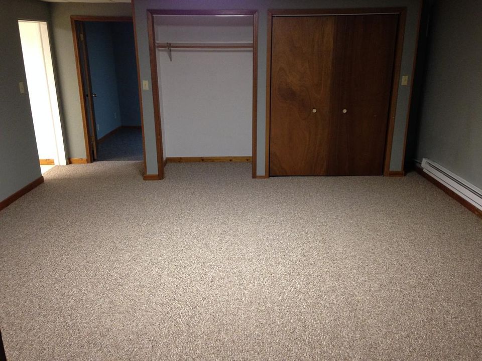 living room with laundry on right, storage nook, bedroom and