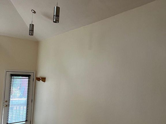 Front door and pendant lights. View from back of apartment.