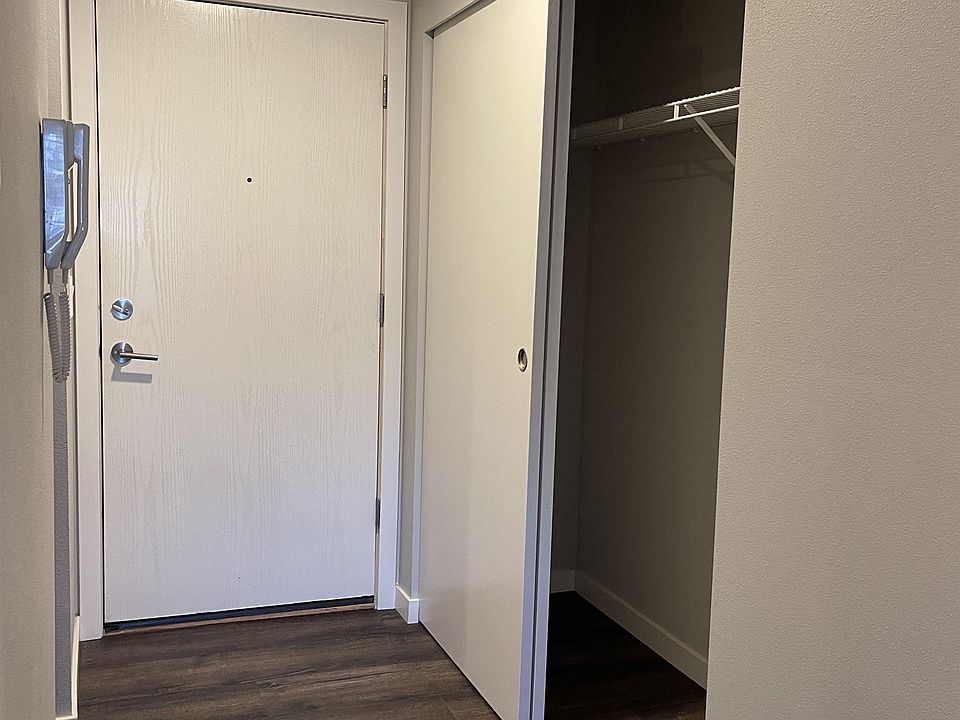 Entry w/ dual sliding door closet and vinyl wood flooring