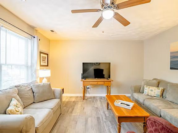 Living room has 50" smart tv for your streaming preferenes. Luxury plank flooring along with a couch, love seat and chair. Blinds and curtains on two front windows.
