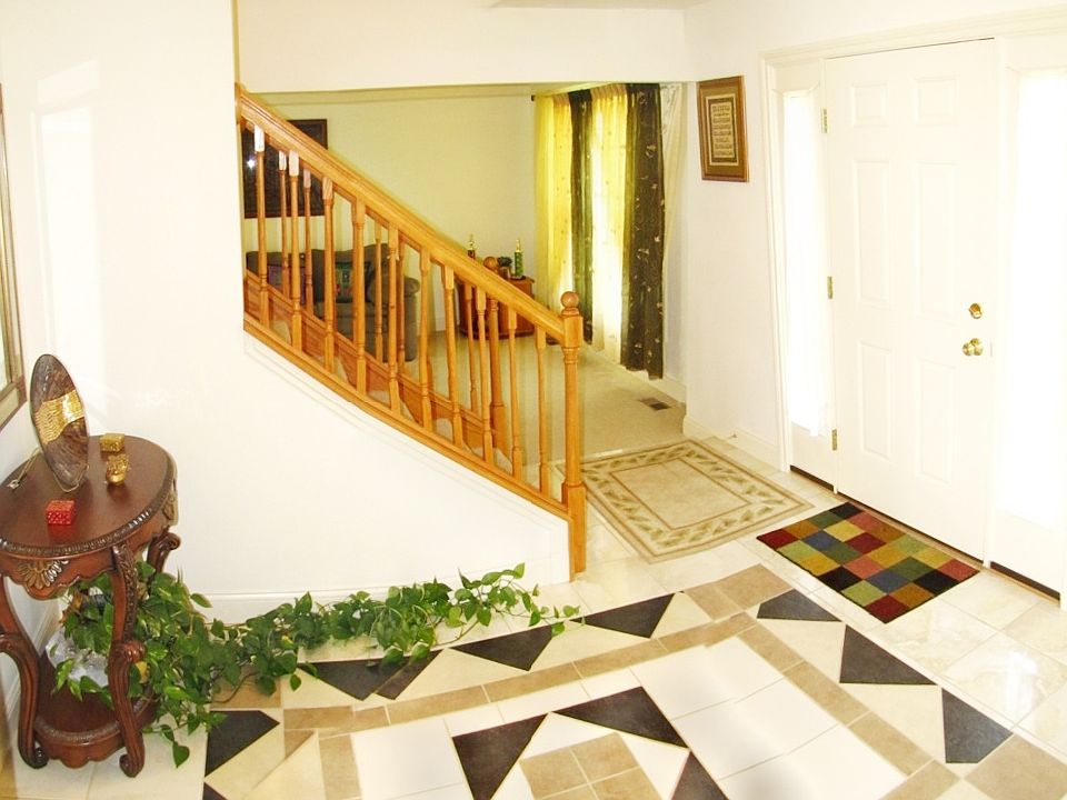 Foyer with artistic tile design, neutral tones for any taste.