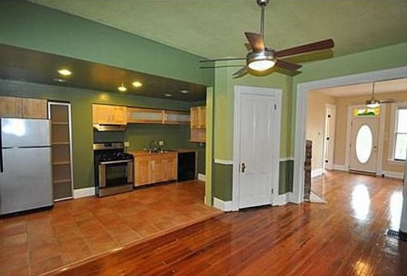 First floor view of updated kitchen and orignal floors.