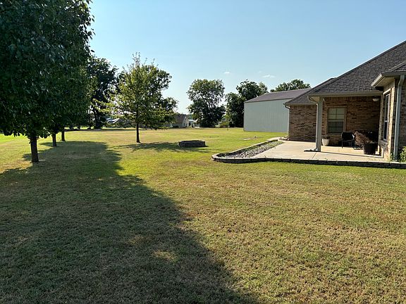 Huge backyard with fire pit.