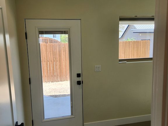 Bedroom with access to covered back patio and yard